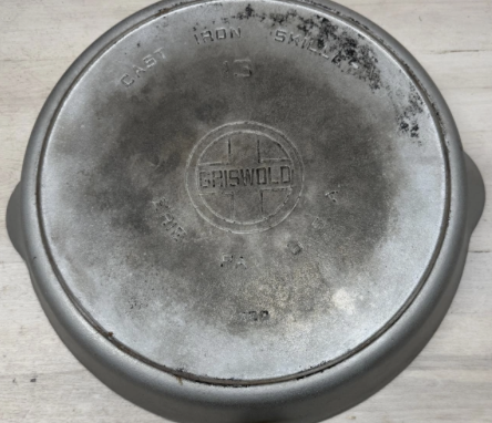 Griswold plated cast iron number 13 skillet with large block logo EPU, heat ring, pattern number 720. Sold for $2,100